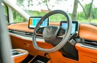 Steering wheel features controls for the music volume, cruise control speed, and telephony. Two-spoke wheel looks modern while the boss houses the horn-pad.